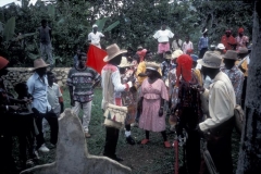 Rara Queen and Kings receive instruction on how to dance before the ancestors at the cemetary